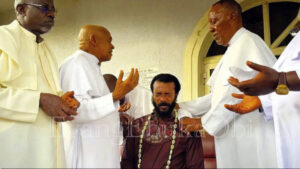 • The senior priests praying for Evangelist Ebuka Obi after his kind gesture.