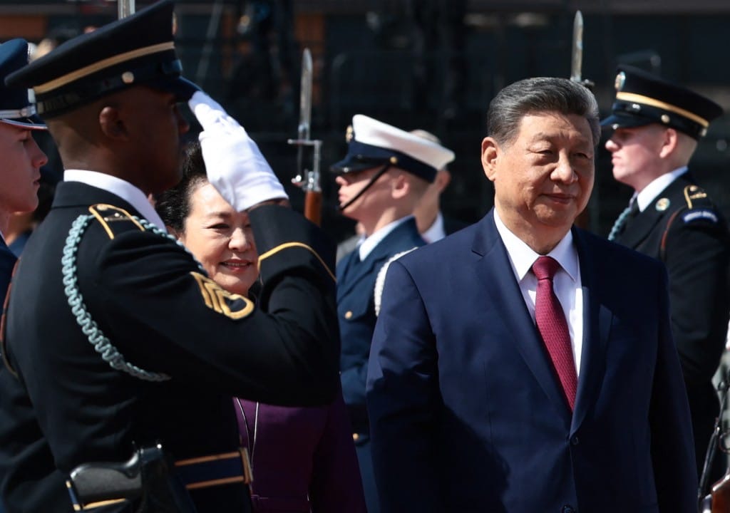 China’s President Xi Jinping and his wife Peng Liyuan walk past a US military honor guard on their way to board an Air China plane upon departure from Joint Base Andrews in Maryland on September 25, 2026. (Photo by Evelyn Hockstein / POOL / AFP)