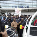 Dr. Ayodele Ogunsan presenting keys of two patrol vehicles to Dr. Kayode Opeifa while officers of NRC police and NSDC command look on