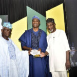 L-R- Fanimokun presenting plaque to Nubi with Abdul