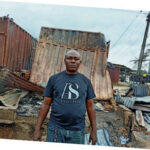 A flustered trader inside his razed shop