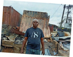 A flustered trader inside his razed shop