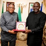 Governor Bassey Otu being presented the Most Improved State GIS/Digital Land Administration Award by Hon Williams Archibong, Director-General of Cross River  State Geographic and Information Agency (CRGIA) in Abuja on Wednesday