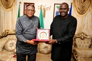 Governor Bassey Otu being presented the Most Improved State GIS/Digital Land Administration Award by Hon Williams Archibong, Director-General of Cross River  State Geographic and Information Agency (CRGIA) in Abuja on Wednesday