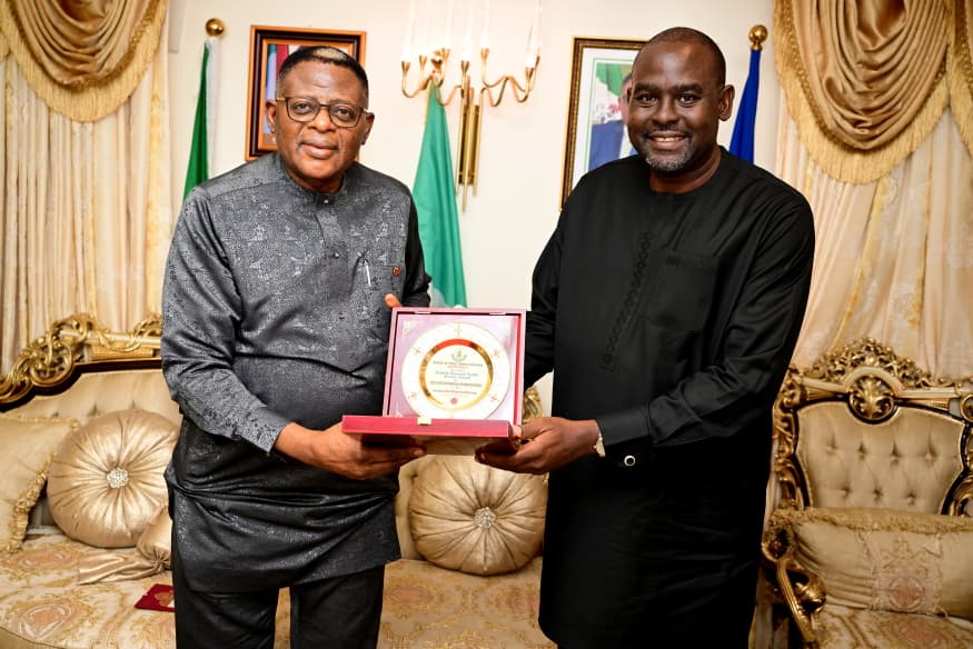Governor Bassey Otu being presented the Most Improved State GIS/Digital Land Administration Award by Hon Williams Archibong, Director-General of Cross River  State Geographic and Information Agency (CRGIA) in Abuja on Wednesday