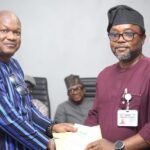 Outgoing Chairman Comrade Wole Dada (left) handing over to Comrade Ekip Ekip Eso