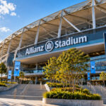 Allianz Stadium in Sydney on a sunny day with Sydney FC logos and an empty entrance plaza